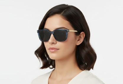 Woman wearing blue sunglasses with a plain background