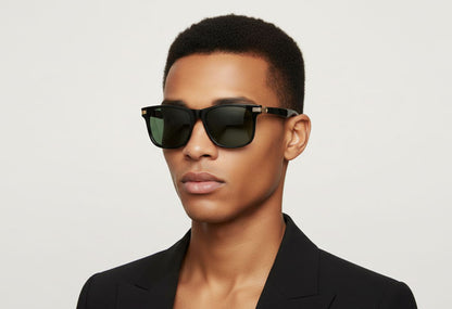 Person wearing black sunglasses and a black outfit on a light gray background