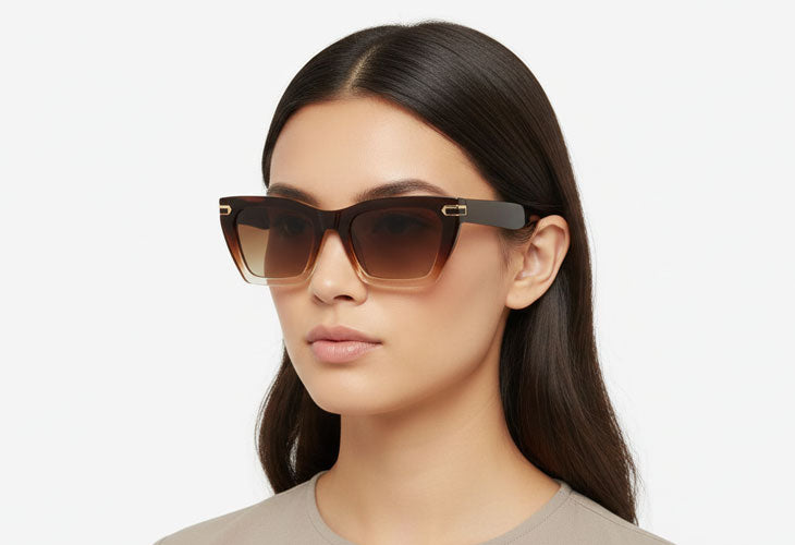 Woman wearing a pair of sunglasses with a plain background