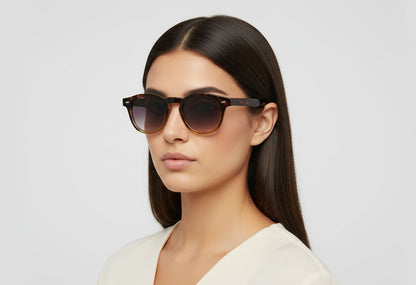 Woman wearing sunglasses with a plain background