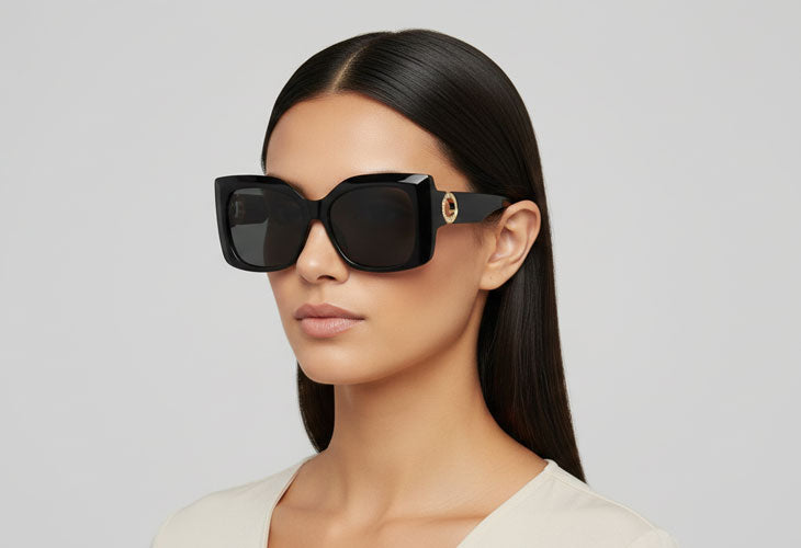 woman wearing black sunglasses with grey background