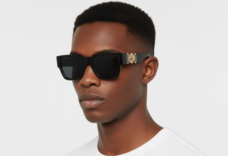 Person wearing black sunglasses with a brand logo on a white background