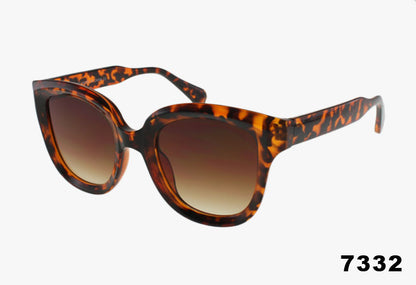 Tortoiseshell sunglasses with brown gradient lenses on a white background