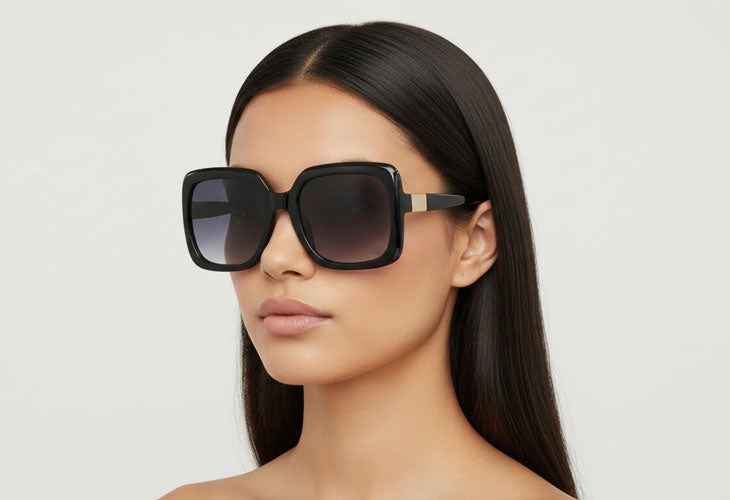 Woman wearing a pair of sunglasses with a plain background