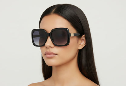 Woman wearing a pair of sunglasses with a plain background