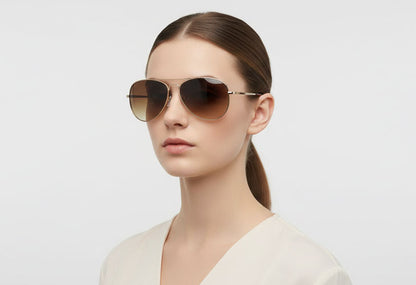 Woman wearing sunglasses with a plain background