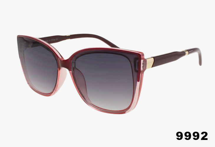 Sunglasses with a maroon frame and gradient lenses on a white background