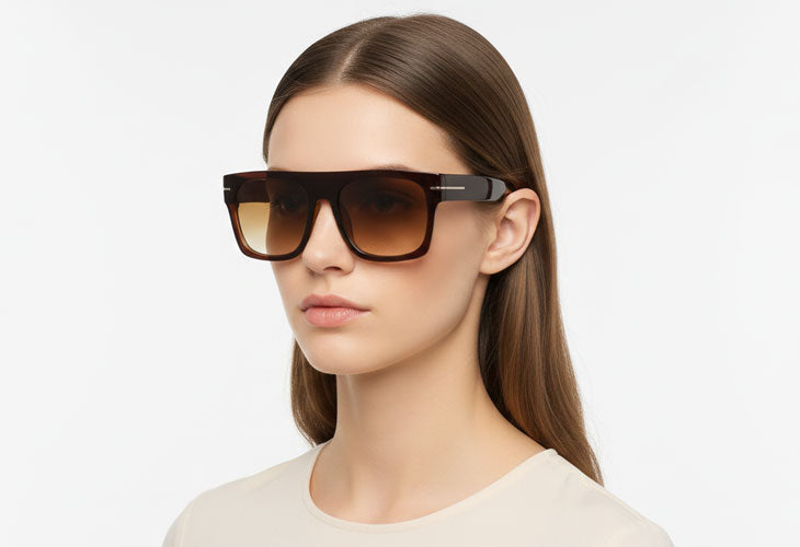 Woman wearing a pair of sunglasses with a plain background